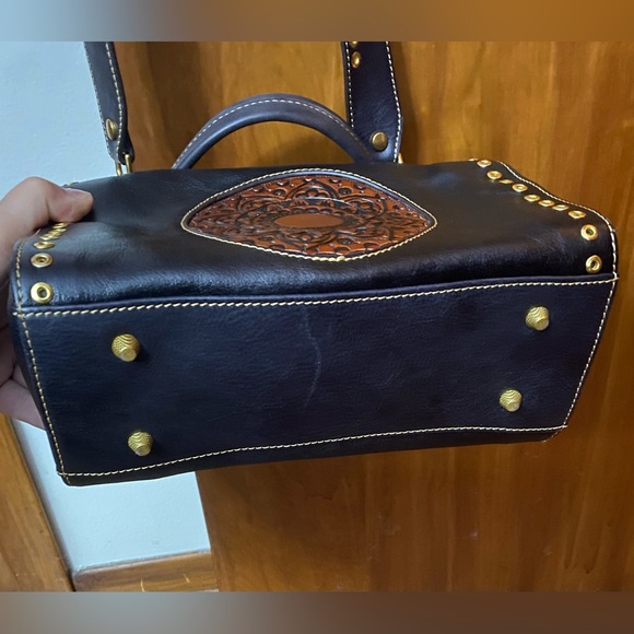 Black leather cross body purse with orange colored medallion on front. - Picture 14 of 14